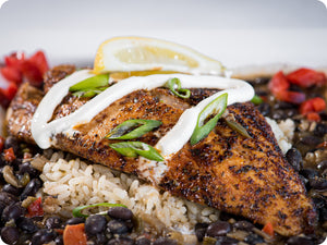 Blackened Rockfish with black beans, rice, and a crema sauce.